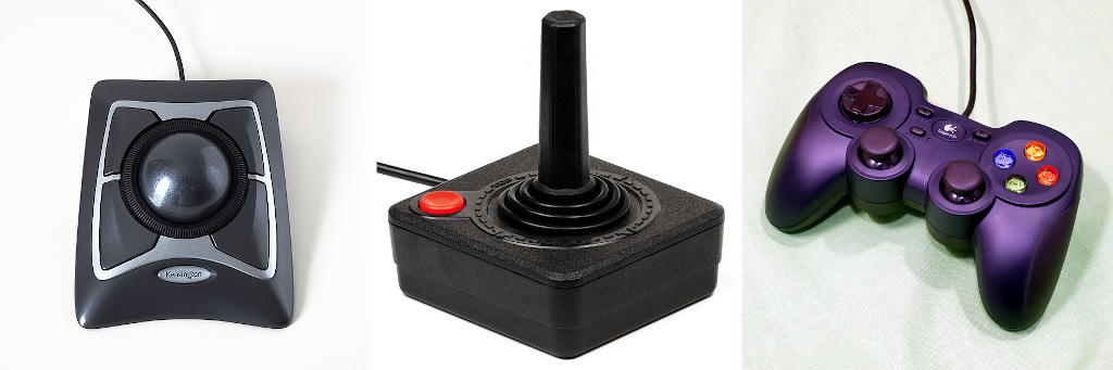 Dispositivos apontadores de posicionamento relativo. Da esquerda para a direita: trackball ([fonte](https://commons.wikimedia.org/wiki/File:Kensington_Expert_Mouse_Wired_Trackball_64325.jpg)), joystick ([fonte](https://commons.wikimedia.org/wiki/File:Atari-2600-Joystick.jpg)), gamepad ([fonte](https://commons.wikimedia.org/wiki/File:Logitech_F310_Gamepad.jpg)).